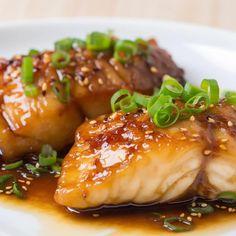 some food on a white plate with sesame seeds