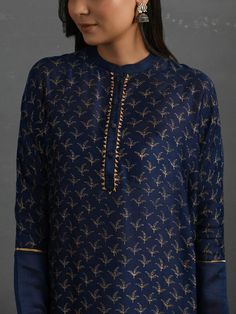 A free-size flowy Indigo chanderi kurta with gold block print, gota detail and pleated hem. Garment measurements (in Inches): Free size: Length - 47", Bust - 61", Waist - 60" Fabric: Chanderi (Cotton silk) Color: Indigo Fit: Model height - 5"7" Fit - Loose/comfortable Technique: Hand block printed in gold with gotta details Instructions: Dry clean only Note: Available in other colors This product will be shipped within 20-25 days of the order placed Silk Kurta With Printed Motifs For Diwali, Gold Long Sleeve Slub Silk Kurta, Silk Straight Kurta With Printed Motifs, Gold Cotton Silk Kurta With Chikankari Embroidery, Gold Kurta With Chikankari Embroidery In Cotton Silk, Traditional Silk Palazzo Set With Block Print, Long Sleeve Cotton Silk Kurta With Gota Work, Chanderi Sharara With Block Print Straight Kurta, Silk Straight Kurta Tunic For Eid