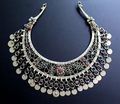 This ornate Afghan torc necklace was handcrafted during the mid-1900's for the nomadic Kuchi tribe of Central Asia. It is an old tribal jewelry neck-ring - not a new reproduction. MEASUREMENTS (1 inch = 2.54 cm): Neckline circumference = 17 inches, including gap Front Drop = 3 inches (distance between upper/lower edges at center front) Necklace width = 8 inches Weight = 7.4 oz Shipping Weight = 14 oz TM image library 9-10-2020 The torc is a distinctive style of neck-ring choker-necklace that has Traditional Round Necklaces For Festivals, Multicolor Bohemian Jewelry With Intricate Design, Traditional One-of-a-kind Necklace For Festival, Traditional Ceremonial Necklaces, Bohemian Necklaces With Intricate Design For Festivals, Bohemian Necklace With Intricate Design For Festival, Bohemian Round Ceremonial Necklace, Traditional One Of A Kind Necklaces For Ceremonial Occasions, Bohemian Round Necklace For Ceremonial Occasions