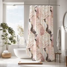 a bathroom with a sink, mirror and shower curtain that has pink flowers on it