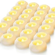 many white candles with yellow lights on them