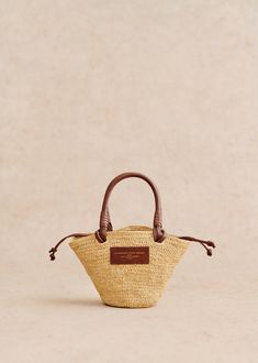 Made in our atelier in Madagascar;Basket carried on the shoulder;Hand-woven raffia exterior;Handle not adjustable;Carried on the shoulder and in the hand;Closes with leather ties;Cotton lining;Length of handles: 10 cm / 46 cm / 3.9 in / 18.1 in;Weight of the bag: 0,4 kg / 14.1 oz;Dimensions: 15 x 31 x 10 cm / 5.9 x 12.2 x 3.9 in Ochre Flowers, Raffia Embroidery, Lifestyle Dresses, Mini Basket, Woven Raffia, Raffia Bag, Basket Bag, Best Bags, Dress Jewelry