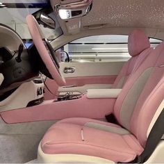 the interior of a car with pink and white leather