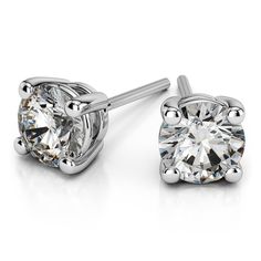 A special pair of 4.5 mm 1/2 ctw moissanite stud earrings in white gold. The sparkling round cut studs are safely set into a white gold four-prong setting with a combined total weight of 0.58 carats. Diamond Earrings Studs Round, Solitaire Pendant Necklace, Solitaire Studs, Moissanite Earrings, Natural Diamond Engagement Ring, Men Diamond Ring, Diamond Stud Earrings, Solitaire Pendant, Eternity Band Diamond