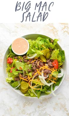 a salad with lettuce, cheese and dressing in it