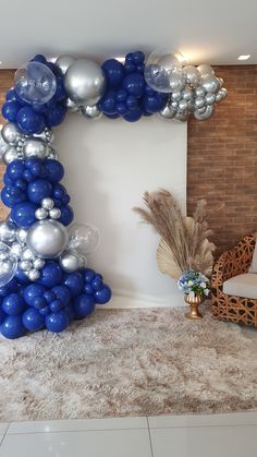 a balloon arch with blue and silver balloons