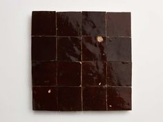 a piece of chocolate that has been cut into squares and placed on a white surface