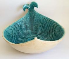 a blue and white bowl sitting on top of a table