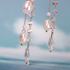 These long tassel dangle drop earrings features pearl like white flower and a long trail of artificial pearls and crystal drop earrings. These earrings make a big picture but light weight to wear, perfect wedding party earrings, bridal earrings, fashion earrings that can pair with your outfit to complete your fashion look. Materials: artificial pearls, resin, alloy, crystalFinish: gold color Jewelry Care: See more information about how to care for your jewelry here. Shipping Policy: Orders will Pearl Drop Chandelier Earrings, Pearl White Dangle Chandelier Earrings For Party, Elegant Long Drop Crystal Earrings With Dangling Beads, White Long Drop Crystal Earrings For Party, Elegant Wedding Crystal Earrings With Dangling Beads, Pearl Dangle Chandelier Earrings For Evening, White Chandelier Earrings With Pearl Chain For Party, Pearl Chandelier Dangle Earrings For Evening, White Long Drop Teardrop Earrings For Party