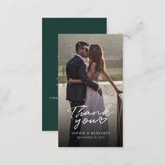 a wedding thank card with an image of a couple kissing in the rain on it