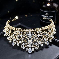 Up your sparkle factor with this romantic tiara design that can complete the most sophisticated of bridal looks. Intricately faceted cubic zirconia work their way across the band and capture the light from every angle with a perfectly translucent appeal. Cast in lightweight alloy and silver/yellow gold/rose gold plated for a flawless finish, the headband measures 2.5" at the tallest point (approx. 6.3cm) and 6" in diameter (approx. 15cm). Two small loops at each end make it easy to attach to you Tiara Design, Swirly Pattern, Wedding Tiara, Bridal Tiara, Clear Rhinestones, Wedding Hair Accessories, Bridal Looks, Gold Rose, Rose Gold Plates