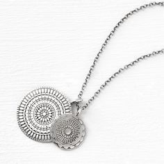 a coin necklace that revives the layered style. our double medallion pendant has two hand-stamped patterned coins strung on an 18" chain, ideal for layering with others in our medallion collection. materials + dimensions sterling silver to brighten, polish with a clean cloth avoid all chemicals + abrasives Medallion Locket Charm Necklace In Amulet Style, Amulet Style Medallion Necklace With Coin Pendant, Engraved Medallion Amulet Charm Necklace, Medallion Necklace With Large Coin Pendant, Sterling Silver Coin Pendant Medallion Necklace, Bohemian Medallion Charm Necklace With Coin Pendant, Bohemian Coin Necklace With Medallion Pendant, Bohemian Charm Necklace With Coin Medallion, Large Coin Pendant Medallion Necklace Amulet