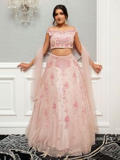 Farah Lehenga is a beautiful ensemble in an eternal blush pink, elevating the bride's attire. The scrupulous embroidery and glint of mirrors and resplendent pearls and glittering stone make it classy and sumptuous. Stitched with soft net fabric, it is inclusive of embroidered dupatta and blouse and lehenga that gives an ultimate, refined and royal look to the bride-to-be at her special occasion. Ideal for weddings and other exclusive events. Key Features: Color: Blush Pink Fabric: Soft net Embel Elegant Organza Lehenga With Pearl Embroidery, Elegant Floor-length Lehenga With Pearl Embroidery, Elegant Wedding Choli With Pearl Embroidery, Glamorous Pearl Embroidery Sets For Reception, Glamorous Hand Embellished Wedding Sets, Pink Hand Embellished Organza Choli, Glamorous Wedding Sets With Pearl Embroidery, Traditional Formal Lehenga With Pearl Embroidery, Formal Festive Lehenga With Pearl Embroidery