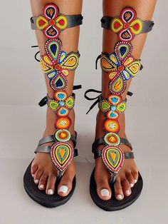 This is a gladiator made using leather and beautiful fine beads. Available in all sizes. Beaded Flat Sandals For Beach, Beaded Flat Heel Sandals For Beach, Beaded Flat-heel Sandals For The Beach, Bohemian Multicolor Flat Sandals, Bohemian T-strap Sandals With Round Toe, Bohemian T-strap Sandals With Round Toe For Vacation, Bohemian Open Toe T-strap Sandals For Vacation, Bohemian Black Barefoot Sandals For Vacation, Bohemian Handmade Open Toe Ring Sandals