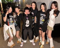 the girls are posing together in front of a white curtain and one girl is holding her hand up to her face