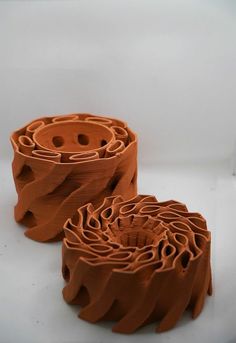 two pieces of clay sitting next to each other