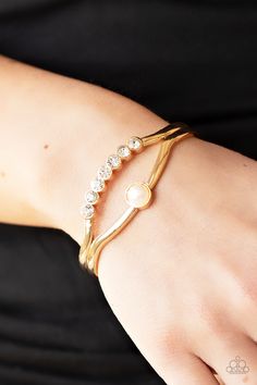 A row of glassy white rhinestones and a solitaire white pearl adorn the layered center of a classic gold cuff, creating a timeless piece around the wrist.

Sold as one individual bracelet. Gold Pearl Bracelet, Gold Bracelet Cuff, Gold Cuffs, Paparazzi Accessories, White Rhinestone, Gold Rhinestone, Classic Gold, Rhinestone Bracelet, Paparazzi Jewelry