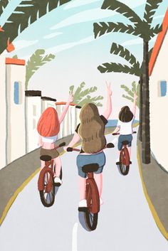 three people riding bikes down a street with palm trees