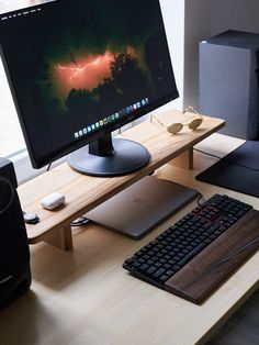 a desktop computer sitting on top of a wooden desk next to a keyboard and mouse