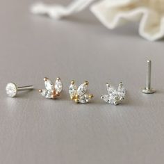 This is a set of a mini CZ tiara ear piercing jewelry removable end, which has three AAA marquise CZ diamonds, with a threadless push back post. RECOMMENDED WEARING POSITION EAR PIERCING - Helix, Earhead/Forward Helix - Tragus, Anti-Tragus/Surface Tragus - Cartilage/Flat - Conch, Inner Conch, Outer Conch - Lobe/Standard Lobe, Upper Lobe MATERIAL - AAA Cubic Zirconia - 925 sterling silver with gold/rose gold plated - 925 sterling silver threadless push back post MEASUREMENT * Removable End Size:- Elegant Hypoallergenic Silver Nose Studs, Elegant Internally Threaded Cartilage Earrings For Wedding, Elegant Hypoallergenic Piercings For Wedding, Elegant Hypoallergenic Wedding Piercings, Dainty Single Cartilage Earring For Wedding, Elegant Adjustable Pierced Nose Ring, Elegant Nose Studs For Weddings, Elegant Hypoallergenic White Gold Nose Rings, Dainty Cubic Zirconia Wedding Piercings