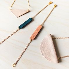 three necklaces with different shapes and colors