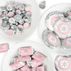 pink and silver candies in white bowls with snowflakes on the plates next to them