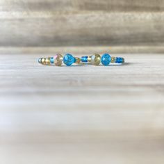 These beautiful rings, will make you look expensive, whilst also being on a budget😉. Handmade out of 0.8mm transparent elastic string, gold and blue seed beads and crystal beads. Make sure to select your ring size and your option, in the sections above.  💖Check out our other ring collections: https://www.etsy.com/shop/Zooheela?ref=seller-platform-mcnav&section_id=48579398 ABOUT DELIVERY: Shipment time might vary, depending on where you live; however, we place a huge importance on the delivery Blue Stackable Jewelry With Round Beads, Adjustable Round Band Bracelet For Gift, Adjustable Blue Birthstone Jewelry, Adjustable Faceted Rondelle Beads Jewelry, Adjustable Rondelle Faceted Bead Jewelry, Dainty Blue Bangle, Dainty Blue Bangle Jewelry, Blue Spiritual Stackable Jewelry, Adjustable Round Band Crystal Ring With Gemstone