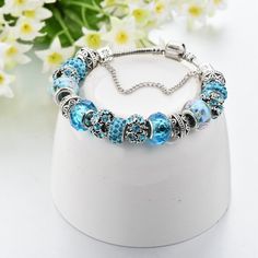 Trendy Blue Flower Bead Bracelet Blue Bangle Jewelry With Large Beads, Turquoise Flower Bracelets With Colorful Beads, Bohemian Blue Charm Bracelet With Colorful Beads, Blue Beaded Flower Jewelry, Blue Flower-shaped Beaded Jewelry, Blue Bangle With Spacer Beads, Blue Spacer Beads Bangle Jewelry, Turquoise Beaded Flower Bracelets, Turquoise Beaded Flower Bracelet