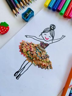 a child's drawing with colored pencils and crayons on the table