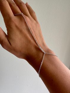 ✨ Perfectly simple silver dainty hand chain featuring a straight crystal pendant. This fits perfectly on your middle finger and attaches as a bracelet.  ✨ Please choose your ring size! ✨ Bracelet measures about 6.5 inches (and will be proportionate to your ring size). ✨ Free shipping in the U.S!  You can see other hand chains here:  https://www.etsy.com/shop/houseofgilt/?section_id=17203243 Follow and tag me on Instagram @houseofgilt @houseofgilt @houseofgilt Minimalist Sterling Silver Chain Bracelet For Party, Dainty Sterling Silver Chain Bracelet For Party, Sterling Silver Adjustable Chain Bracelet For Party, Adjustable Sterling Silver Chain Bracelet For Party, Adjustable Silver Chain Ring For Parties, Silver Hand Chain, Silver Adjustable Body Jewelry For Gift, Adjustable Silver Body Jewelry Gift, Dainty Silver Jewelry With Extender