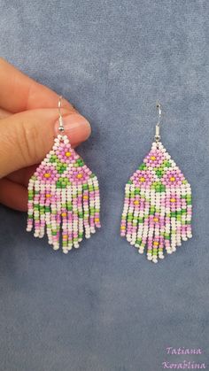 These handmade unique earrings with abstract floral print are made of high-quality Czech beads and strong synthetic thread. I use my author's scheme . These earrings are elegant, fashionable, and highly versatile, suitable for everyday wear. Color: white,pink, green, yellow . 100% hand made with love! Measurements: Length-about 7cm (with schwenze) , Width -3 cm Materials: Silver plated ear hooks Czech glass beads Nylon Thread Handmade White Beaded Drop Earrings, White Bohemian Flower Earrings With Dangling Beads, White Flower Shaped Beaded Earrings With Colorful Beads, White Handmade Drop Flower Earrings, Handmade White Drop Flower Earrings, White Flower-shaped Jewelry With Dangling Beads, Handmade White Flower Bead Earrings, Handmade White Dangle Earrings, Bohemian White Round Bead Flower Earrings