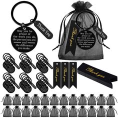 an assortment of black and gold keychains, tags, and other items in a bag