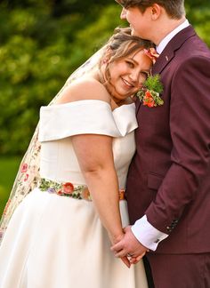 a bride and groom posing for the camera