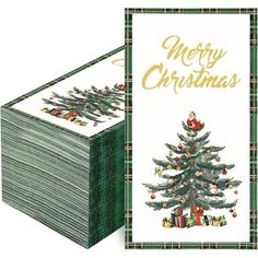 a stack of money sitting next to a christmas tree on top of a white table