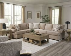 a living room with two couches and a coffee table in front of the window