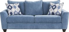 a blue couch with two pillows on it