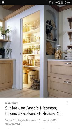 an open refrigerator in a kitchen next to a counter top with baskets on the shelves