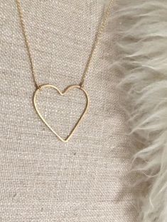 "Open Heart Necklace:  * Beautiful premium 14 karat gold-filled or sterling silver heart is hand-shaped and forged lending to the artisan quality that we love. * Choose your pendant size Regular heart: approximately 1\" Large heart: approximately 1.375\"W x 1.5\"H * Dainty and light Rolo chain gives this necklace a modern, smooth look that is so pretty. It's a perfect match for the elegant open line style heart pendant. * Comes in 17\" length chain with an option to add a 2\" extender chain. Ple Hammered Heart-shaped Jewelry Gift, Minimalist Heart-shaped Nickel-free Jewelry, Minimalist Nickel-free Heart-shaped Jewelry, Minimalist Heart Shaped Nickel-free Jewelry, Minimalist Nickel-free Heart Jewelry, Handmade 14k Gold Heart Jewelry, Dainty Heart-shaped Brass Jewelry, Minimalist 14k Gold Filled Open Heart Jewelry, Handmade Everyday Heart Pendant Necklace