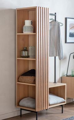 a wooden shelf with some items on it and a rug in the corner next to it