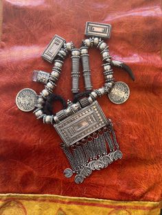 Here is an amazing, antique necklace from Oman.  The main pendant measures approximately 5 3/4" (14,55 cm) long, including the dangles and ~ 3 7/8" (9,85 cm) wide.  This is a truly old piece and the silver is high grade with fantastic patina and wear patterns.  It has two amulets, one of glass and one of horn (likely antelope).  This piece is strung on what seems to be woven goat hair.  The central amulet opens.   This piece weighs ~ 436 grams. Traditional Ceremonial Beaded Pendant Necklaces, Traditional Ceremonial Pendant Beaded Necklaces, Traditional Ceremonial Beaded Pendant Necklace, Traditional Round Necklaces For Festivals, Bohemian Long Necklace For Ceremonial Occasions, Bohemian Long Necklace For Ceremonies, Ceremonial Necklaces With Intricate Round Beads, Traditional Pendant Necklace For Festivals, Traditional Ceremonial Necklace With Round Beads