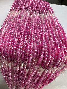 pink and white beads are stacked on top of each other