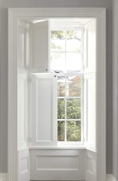 an open window in a white painted room