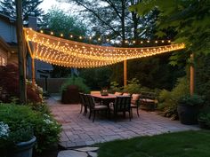 an outdoor patio with lights strung over it