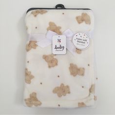 a baby blanket with teddy bears on it and a tag attached to the back of it