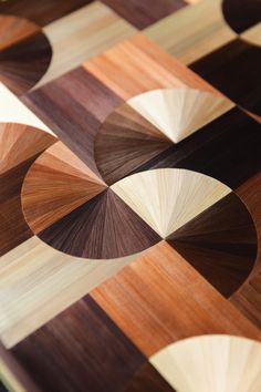 a close up view of a wooden table top with circles and lines on the surface