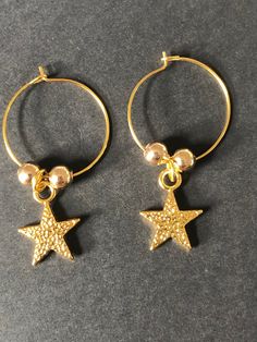 Handmade gold star hoop earrings  ⭐️ Gold plated hoop earrings with gold plated star charms & beads ⭐️ Lightweight & easy to wear Purchasing as a gift? Upgrade to a gift box: https://etsy.me/3gDqVD1 Celestial Gold Dangle Hoop Earrings, Celestial Gold Hoop Earrings Gift, Gold Celestial Small Hoop Earrings, Gold Star-shaped Hoop Earrings With Ear Wire, Gold Star Charm Hoop Earrings, Handmade Star-shaped Hoop Earrings For Gift, Gold Star-shaped Jewelry With Dangling Charms, Gold Hoop Earrings With Star Charm For Gift, Celestial Gold Hoop Earrings Nickel Free