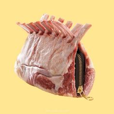 a piece of raw meat with zippers on it's side, in front of a yellow background