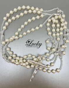 Ivory Pearls set apart with small crystal beads attached to a classic crucifix (choice of Gold or Silver Cross) adorn this lasso exclusively designed by Lucky Collections™. Available on www.ProBridalUSA.com *High-quality Ivory Pearls and Brilliant Crystals, Silver-Gold Plated Cross *Handmade with Love *The Lasso has two loops. Each loop fits one person. * Safekeep the memorable moment of Lasso Unity Ceremony in a lasso box also designed by Lucky Collections™ * Ideal for Spanish Catholic Wedding, Elegant Silver Rosary For First Communion, Elegant Pearl Beaded Rosary, Elegant Pearl White Pearl Rosary, Silver Pearl Bridal Accessories For Bride, Elegant Pearl Rosary For First Communion, Elegant Beaded Wedding Rosary, Silver Pearl Bridal Accessories, Silver Wedding Rosary With 8mm Beads, Elegant Pearl Rosary With 8mm Beads