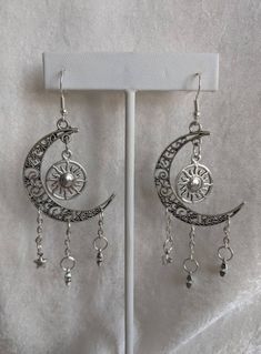 A gorgeous pair of earrings featuring earth's surrounding celestial bodies: the moon, the sun, and the stars. Choose between silver as pictured or bronze! Mystical Silver Star Jewelry, Mystical Silver Star-shaped Jewelry, Celestial Style Silver Metal Jewelry, Celestial Style Nickel-free Metal Hoop Earrings, Celestial Star-shaped Earrings For Pierced Ears, Celestial Metal Hoop Earrings, Celestial Metal Hoop Earrings Nickel Free, Nickel Free Celestial Metal Hoop Earrings, Celestial Style Metal Hoop Earrings Nickel Free