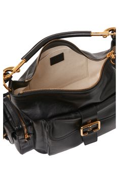 This runway-featured camera bag has a utilitarian feel with a multipocket design but still has the signature free spirit of the Chloé girl. The shiny buffalo leather will patina with time, while the revamped golden buckles nod to the label's cult-favorite Paddington bag. Top zip pocket Removable top-carry handle; removable, adjustable shoulder strap Exterior magnetic-flap pocket; two side pockets with flap and zip closures Interior wall pocket Structured silhouette with flat base for stability C Elegant Bags, Buffalo Leather, Chloe Bag, Strap Top, Zip Pouch, Strap Tops, Wallet Bag, Medium Bags, Handle Bag